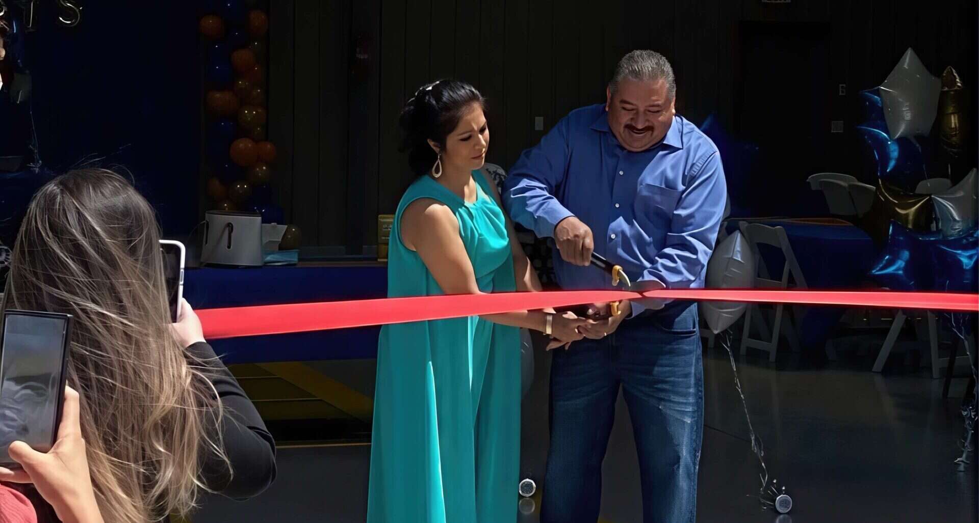 Two Albuquerque business owners cutting the ribbon on their business opening